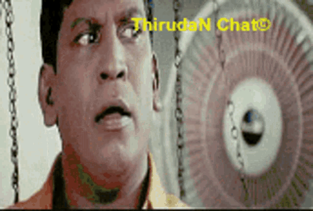 a close up of a man 's face with a fan in the background and the words thiruden chat visible
