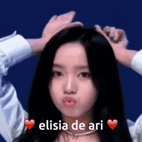 a woman making a face with the words elisia de ari written on the bottom