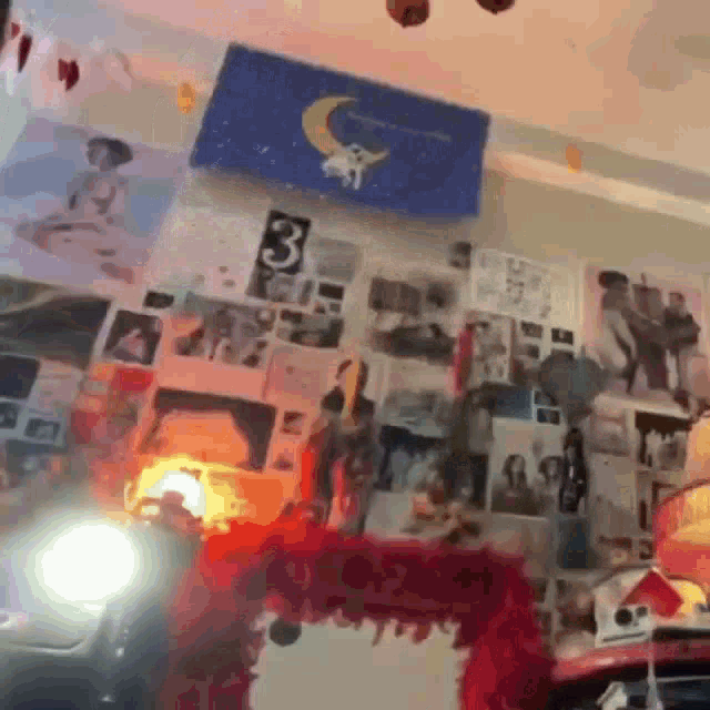 a room with a lot of pictures on the wall and a mirror on the shelf .