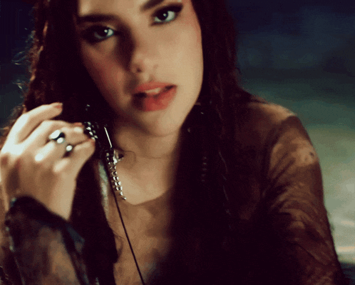 a close up of a woman 's face with a ring on her left hand