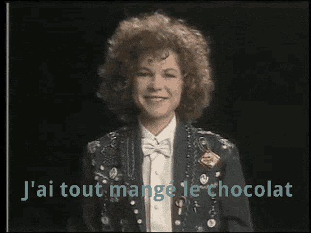 a woman wearing a jacket and bow tie says j'ai tout mange le chocolat
