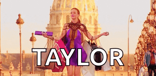 a woman is holding shopping bags in front of a building with the name taylor on it