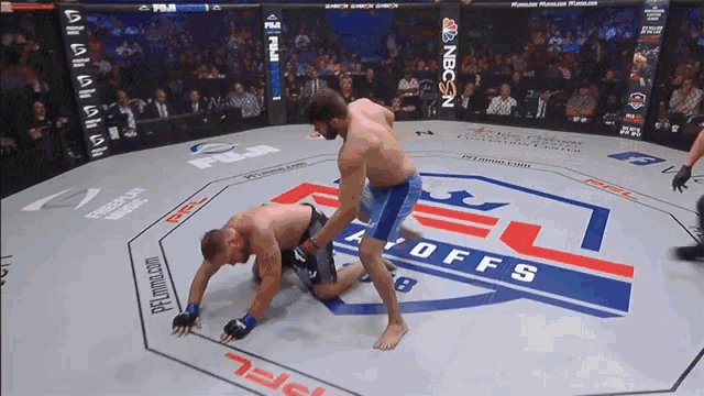 two men are wrestling in a ring that says offs on the floor