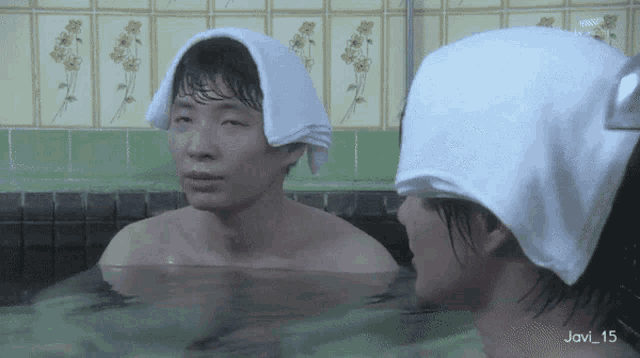 a man in a bathtub with a towel on his head and the number 15 on the bottom