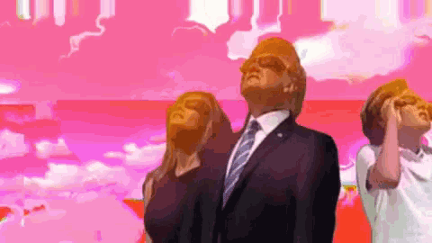 a man in a suit and tie stands in front of a pink background