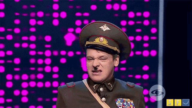 a man in a military uniform making a face