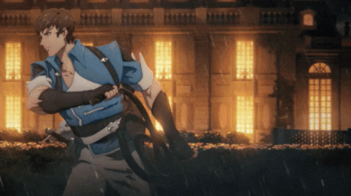 a man in a blue jacket is running in front of a building at night