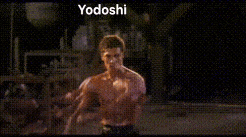 a man is standing in a boxing ring with the word yodoshi written on the bottom .