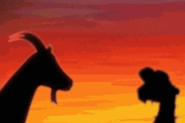 a silhouette of a goat and a chicken standing next to each other in front of a sunset .