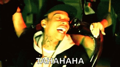 a man is laughing in a chair with the word tahahaha written on the bottom