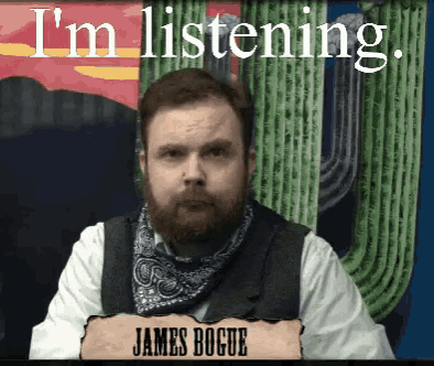 a man with a beard and a bandana says i 'm listening in front of a cactus