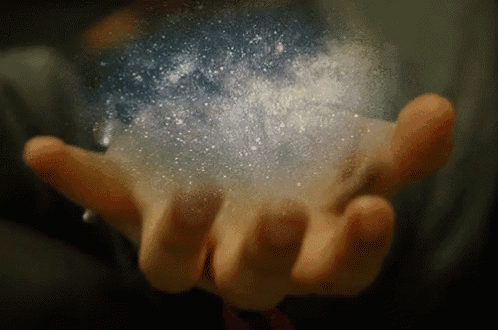 a person is holding something in their hand that looks like a starry sky