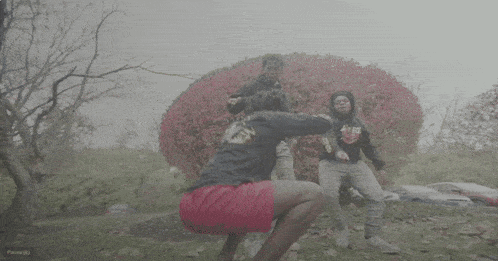 a man wearing a black speed shirt is running in the fog