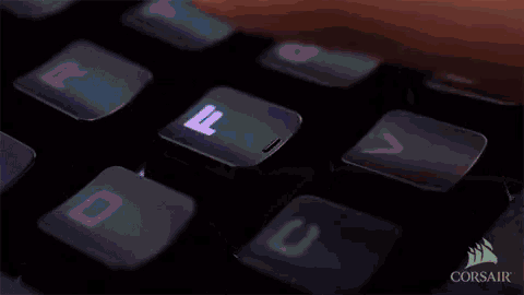 a person is typing on a keyboard with corsair on the bottom right