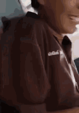 a close up of a person 's face with a cell phone in the background .