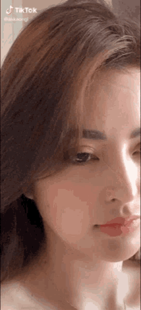 a close up of a woman 's face with long hair and red lips
