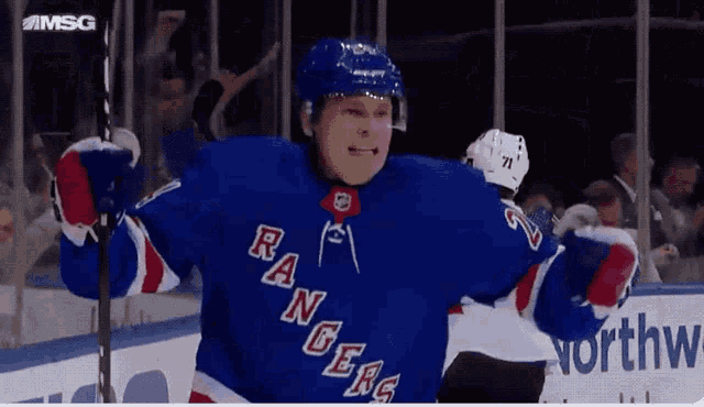 a hockey player for the new york rangers is celebrating a goal