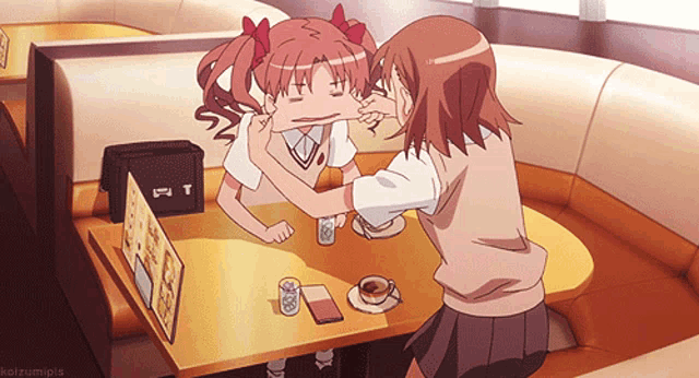 two anime girls are sitting at a table with a sign that says t