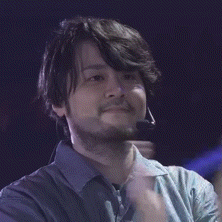 a man with a beard wearing a microphone on his head