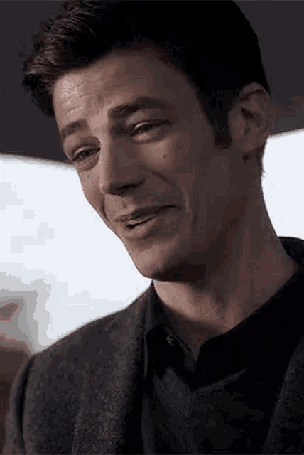 a close up of a man 's face with a slight smile on it .