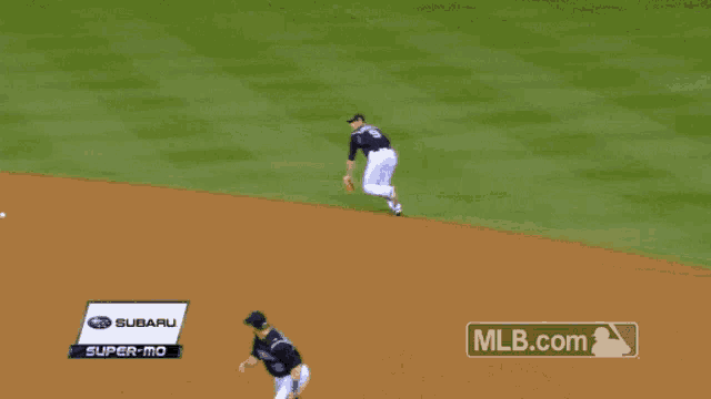 a baseball player with the number 9 on his jersey is sliding into base