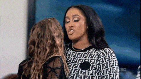 two women are standing next to each other and having a conversation .