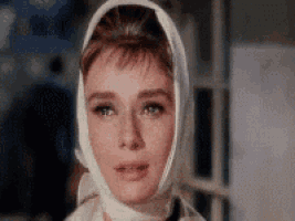 a woman wearing a white scarf around her head .