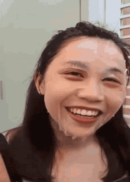 a close up of a woman 's face with a lot of white powder on it .