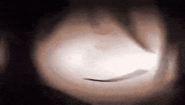 a close up of a person 's face with a light behind it