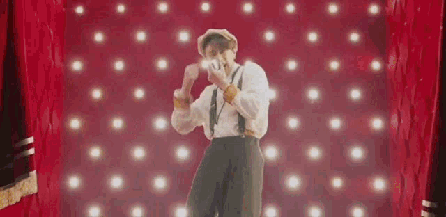 a group of men are dancing in front of a circus entrance .