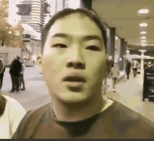 a close up of a man 's face with his mouth open .