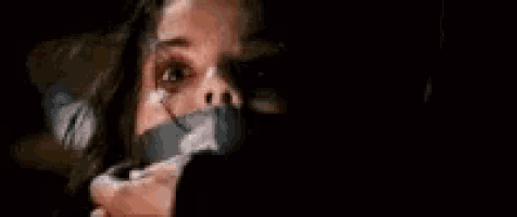 a woman is sticking out her tongue while holding a knife in her hand .