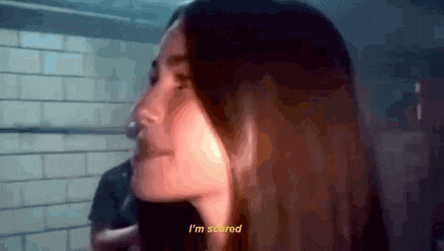 a close up of a woman 's face with the words i 'm scared on the bottom