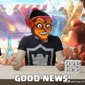 a man is sitting at a table with a cartoon character on his head and says `` good news '' .