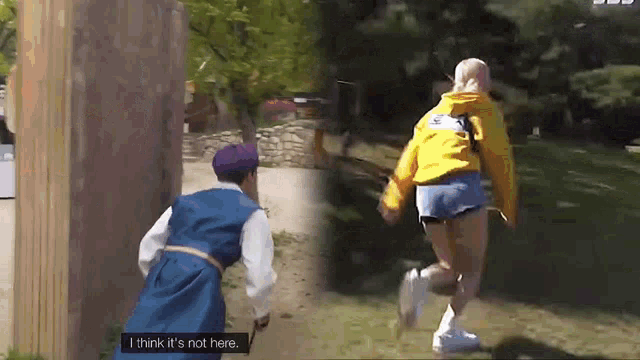 a man in a blue robe is standing next to a woman in a yellow hoodie .