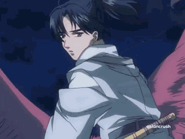 a boy with a ponytail is holding a sword in his hand .
