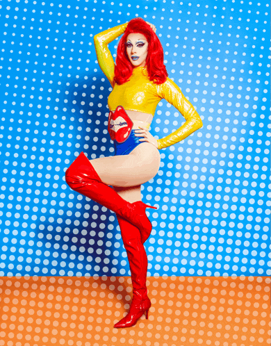 a woman with red hair is wearing a rolling stones outfit and red boots