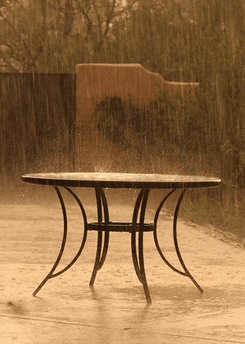 a table in the rain with the letter h on the top
