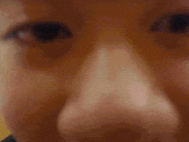 a blurry picture of a person 's face with a yellow background .