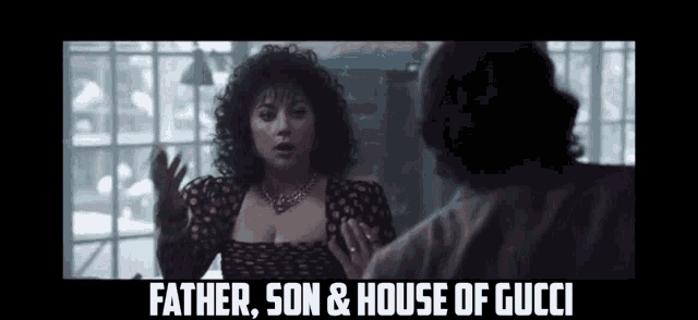 a woman with curly hair is talking to a man with the words father son & house of gucci on the bottom