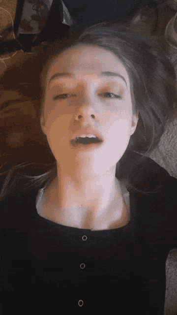 a close up of a woman making a face with her mouth open