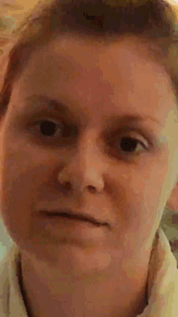a close up of a woman 's face with a yellow eye