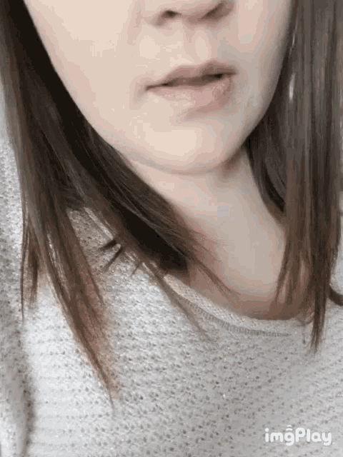 a close up of a woman 's face with the words imgplay visible