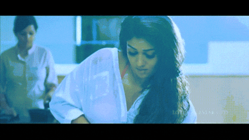a woman in a white shirt with the word lotus on the bottom left