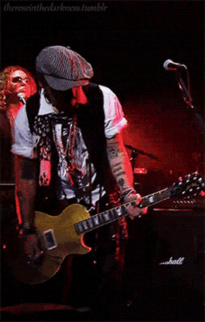 a man singing into a microphone while another man plays a keyboard in front of a krone sign
