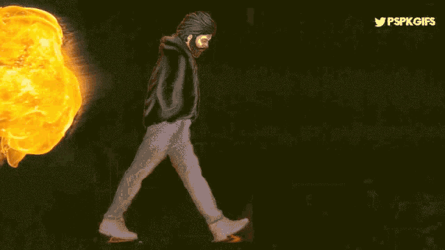 a man is walking in front of a fire with the words power star written on the bottom