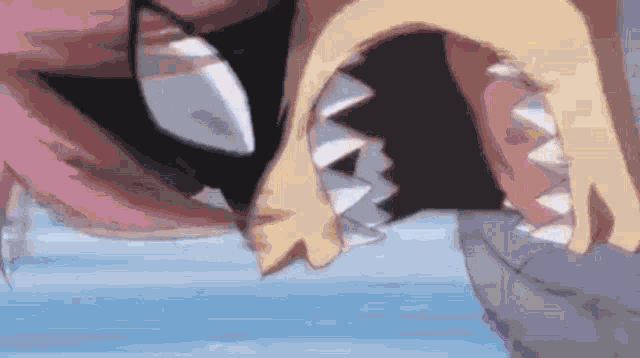 a close up of a person 's mouth with sharp teeth .