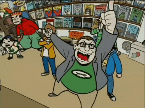 a man in a green shirt with the letter g on it stands in front of a sign that says atomic comics