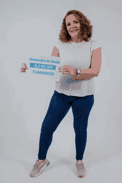 a woman holds a sign that says alessandra de souza
