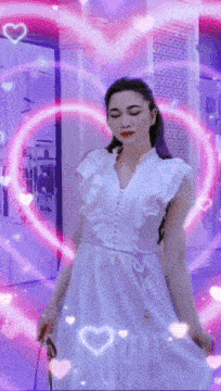 a woman in a white dress stands in front of a pink heart